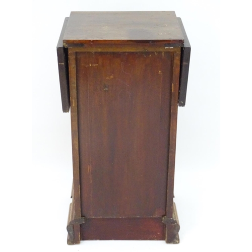 72 - A mahogany bedside / pot cupboard with drop flap top. Approx. 31 1/2