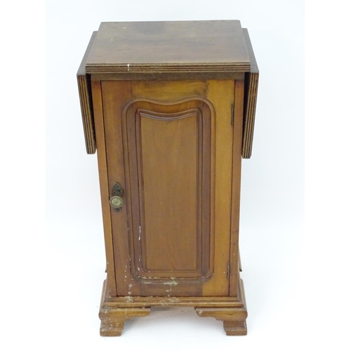 72 - A mahogany bedside / pot cupboard with drop flap top. Approx. 31 1/2