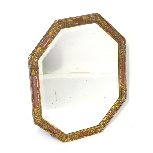 87 - A mirror with a red and gilt frame