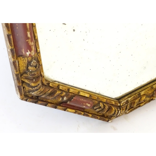 87 - A mirror with a red and gilt frame