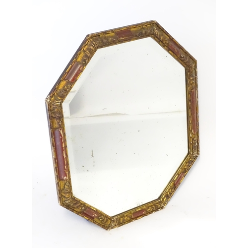 87 - A mirror with a red and gilt frame