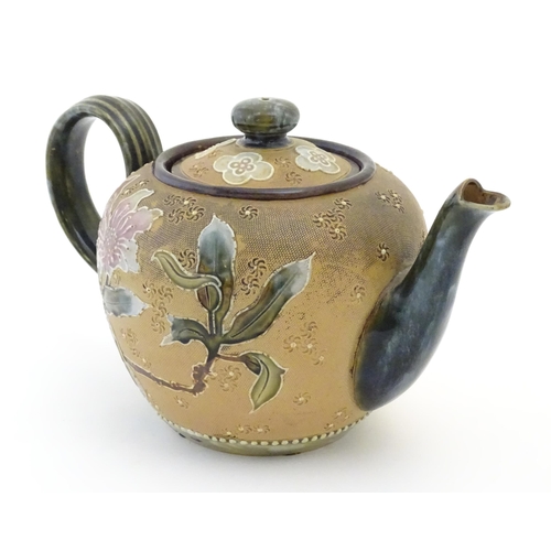 91 - A Royal Doulton stoneware teapot decorated with flowers and foliage. Marked under Doulton Slaters Pa... 