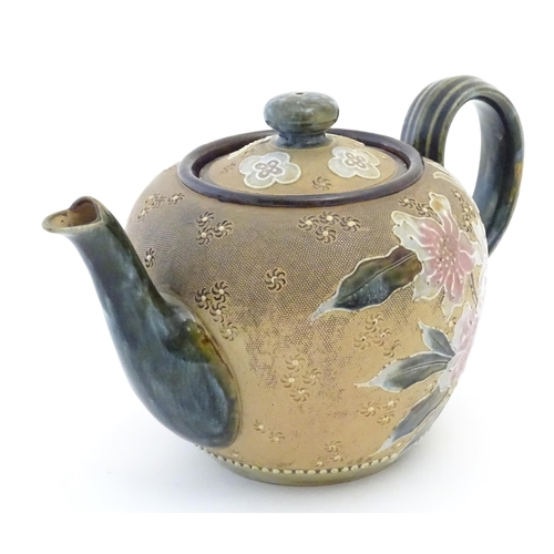 91 - A Royal Doulton stoneware teapot decorated with flowers and foliage. Marked under Doulton Slaters Pa... 