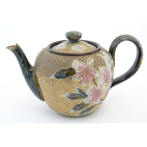 91 - A Royal Doulton stoneware teapot decorated with flowers and foliage. Marked under Doulton Slaters Pa... 