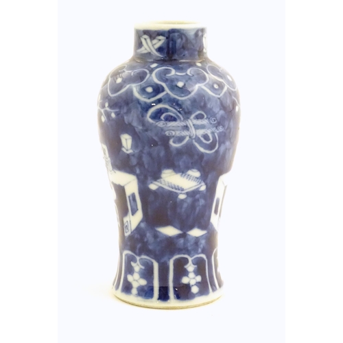 7 - A small Chinese blue and white vase decorated with flowers in a vase and banded borders. Character m... 