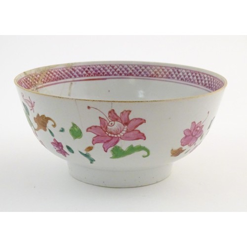 10 - A Chinese famille rose bowl decorated with flowers and foliage, with floral motif to centre of inter... 