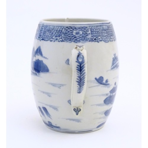 24 - A Chinese blue and white export mug of barrel form decorated with an Oriental landscape with pagodas... 