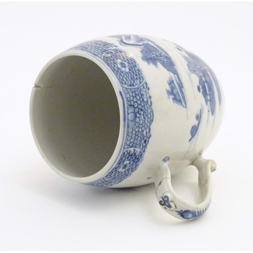 24 - A Chinese blue and white export mug of barrel form decorated with an Oriental landscape with pagodas... 