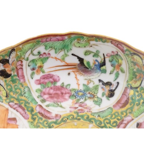 28 - A Chinese / Cantonese plate decorated with figures, birds, butterflies, flowers, and scrolling folia... 