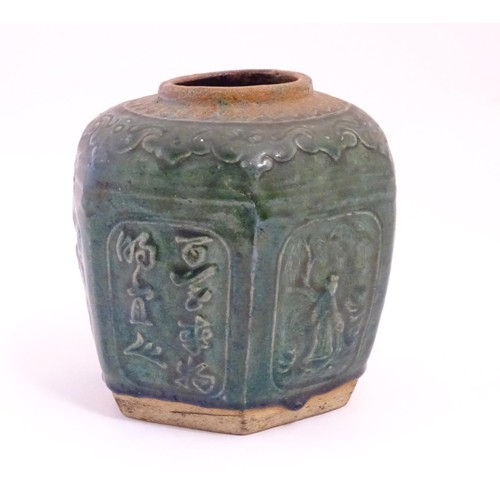33 - A Chinese hexagonal Shiwan ginger jar / vase with moulded floral, foliate, bird and script detail wi... 