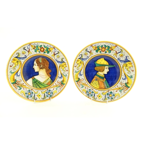 41 - Two Italian majolica portrait plates with folate and mask detail to borders. Signed under S Volpi, D... 
