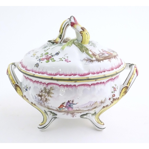 42 - A French lidded tureen with foliate formed handles and standing on four out swept feet, the lid with... 