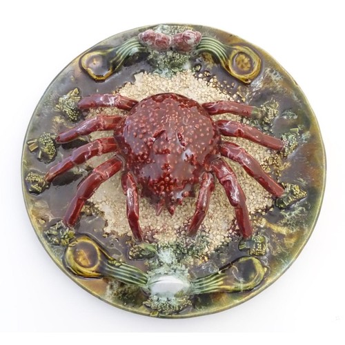 44 - A 20th Portuguese Palissy style majolica dish / plate with an applied model of a crab on a bed of sa... 
