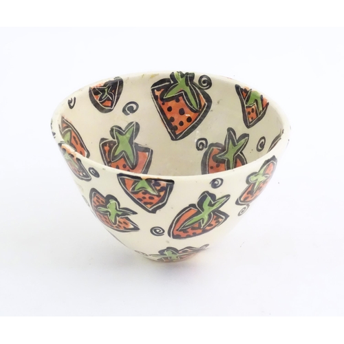 50 - A studio pottery jug and bowl decorated with hand painted strawberry detail by Liz Riley. Marked und... 