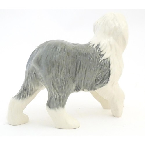 98 - Two Beswick models of dogs comprising a Yellow Labrador, no. 1548, and an Old English Sheepdog, no. ... 