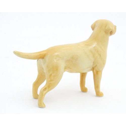 98 - Two Beswick models of dogs comprising a Yellow Labrador, no. 1548, and an Old English Sheepdog, no. ... 