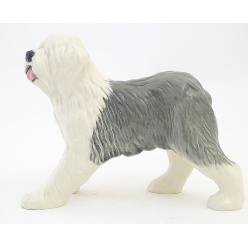 98 - Two Beswick models of dogs comprising a Yellow Labrador, no. 1548, and an Old English Sheepdog, no. ... 