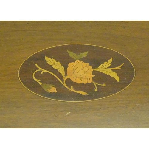1027 - A late 19th / early 20thC mahogany tray of oval form with twin handles and central floral and foliat... 