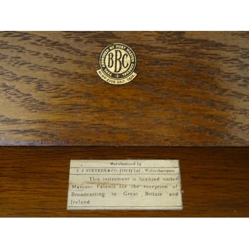 1064 - An AJS  'Type F' wireless receiver table-top valve radio, in a fitted oak case with BBC label, manuf... 