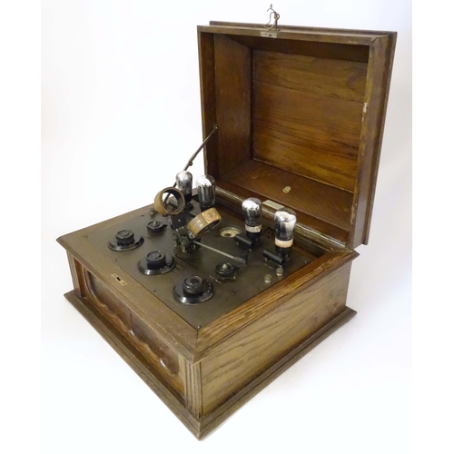 1064 - An AJS  'Type F' wireless receiver table-top valve radio, in a fitted oak case with BBC label, manuf... 