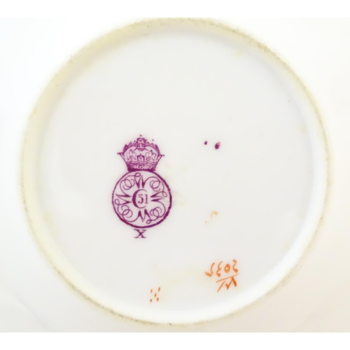 146 - A Royal Worcester coffee cup and saucer decorated with flowers, foliage and berries. Marked under. T... 