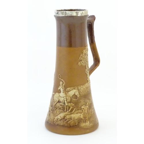 88 - A Royal Doulton two tone jug of elongated form, with relief decoration depicting hunting scenes with... 