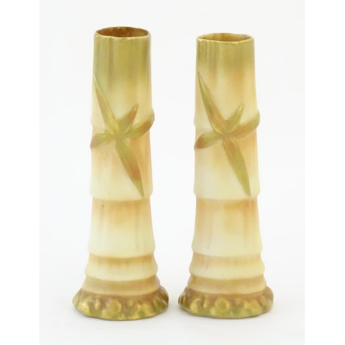 91 - A pair of Royal Worcester spill vases with relief bamboo detail. Marked under with 1049. Approx. 5