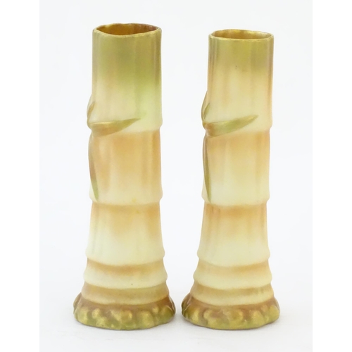 91 - A pair of Royal Worcester spill vases with relief bamboo detail. Marked under with 1049. Approx. 5