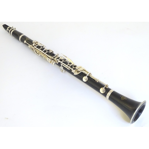 1062 - Musical Instrument : a late 20thC E11 clarinet by Buffet Crampon & Cie, Paris. Constructed from turn... 