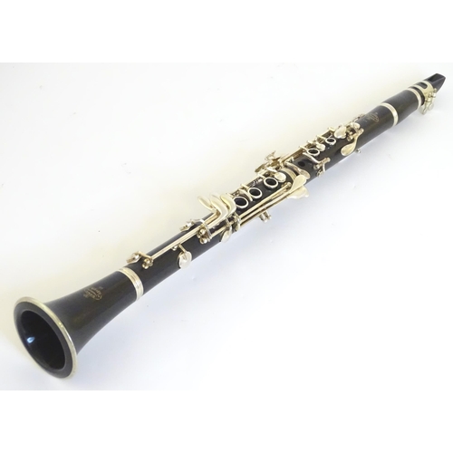 1062 - Musical Instrument : a late 20thC E11 clarinet by Buffet Crampon & Cie, Paris. Constructed from turn... 