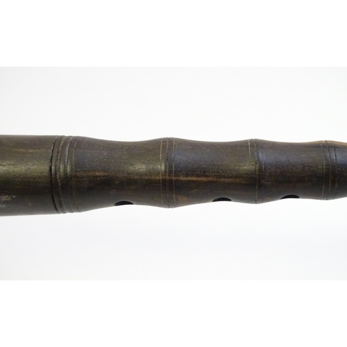 1063 - Musical Instrument : a mid 20thC Chinese suona trumpet, the turned and carved hardwood pipe with rem... 