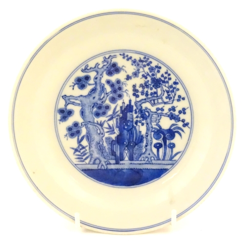 11 - A Chinese blue and white plate decorated with trees and flowers, the reverse decorated with figures ... 