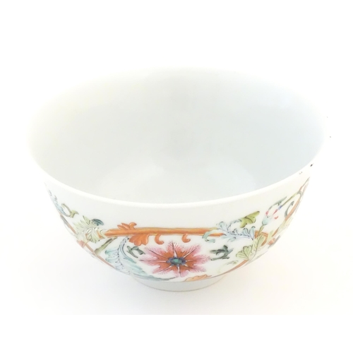 13 - A small Chinese famille rose bowl decorated with scrolling floral and foliate detail, and bat detail... 