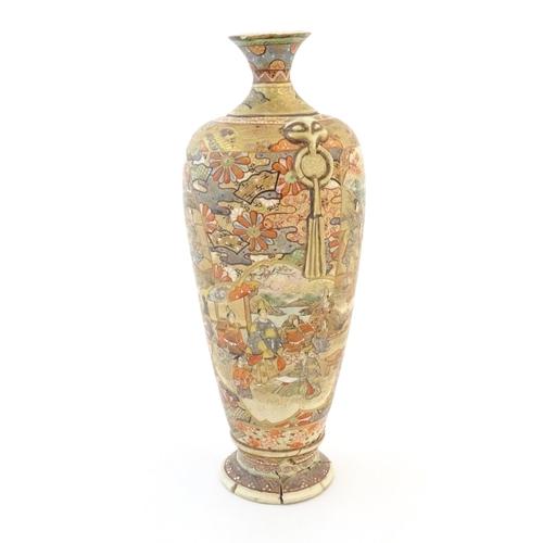 16 - A Japanese satsuma vase with relief twin handles and panelled decoration depicting figures in landsc... 