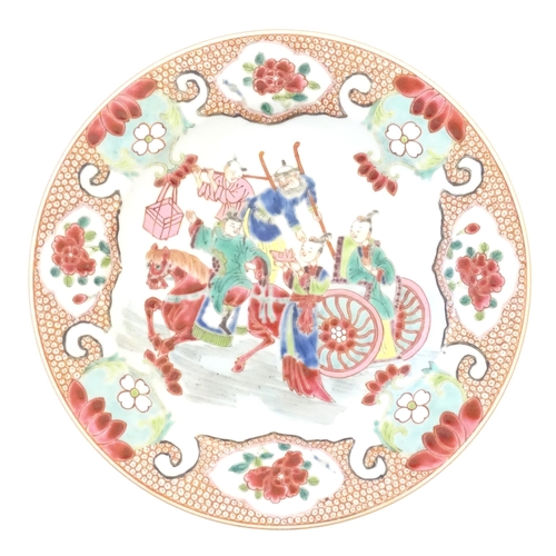 19 - A Chinese famille rose plate decorated with figures and a horse and cart, bordered by flowers and fo... 