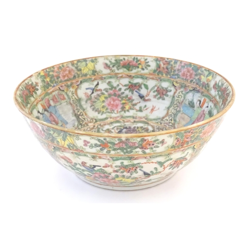 22 - A Cantonese famille rose bowl with panelled decoration depicting figures in traditional dress in var... 