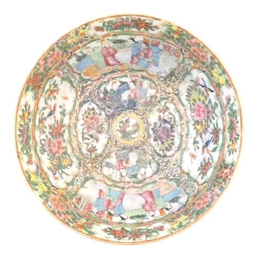 22 - A Cantonese famille rose bowl with panelled decoration depicting figures in traditional dress in var... 