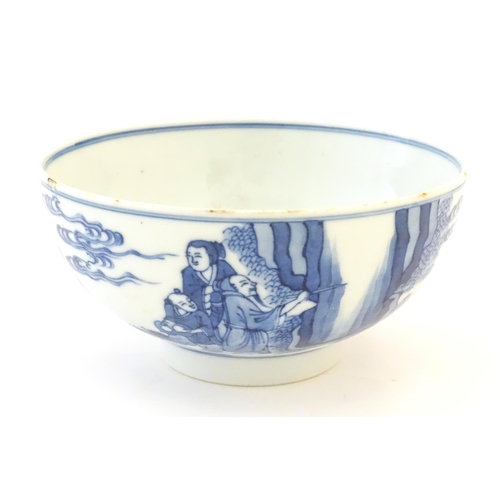 23 - A Chinese blue and white bowl decorated with figures in a garden landscape with lanterns. Character ... 