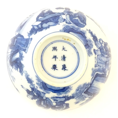 23 - A Chinese blue and white bowl decorated with figures in a garden landscape with lanterns. Character ... 