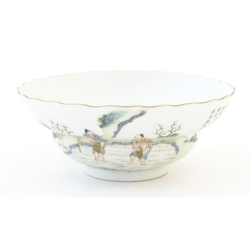 26 - A Chinese stepped bowl decorated with figures in a landscape, figures paddling / sowing seeds and ch... 
