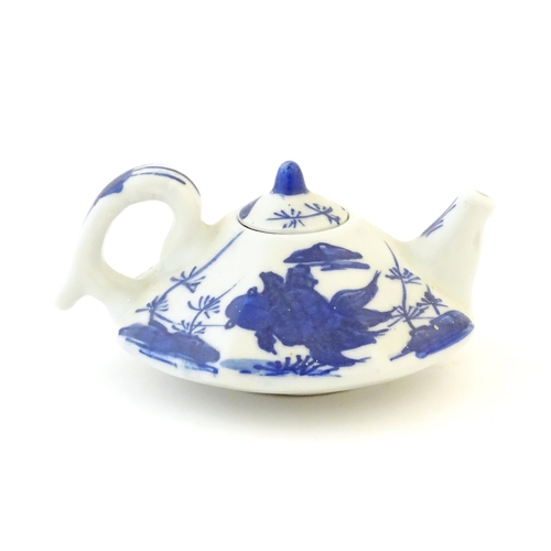 35 - A small Chinese blue and white teapot of octagonal form decorated with koi / carp fish. Character ma... 