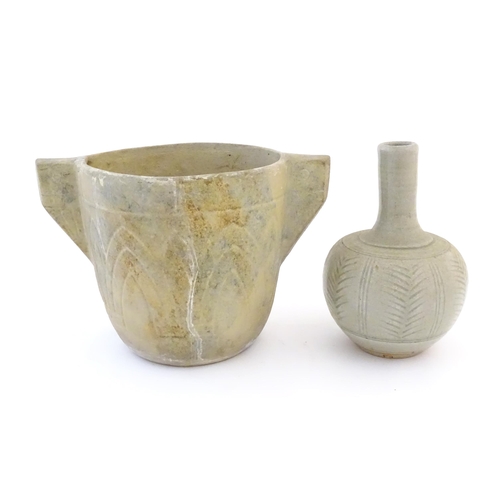 51 - Two items of studio pottery comprising a bottle vase with incised stylised foliate detail. Impressed... 