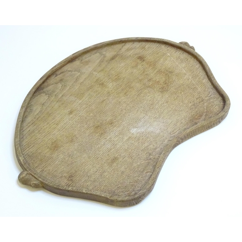 1069 - A 20thC Robert Thompson of Kilburn / Mouseman (1876-1955) oak kidney shaped tea tray with twin carve... 