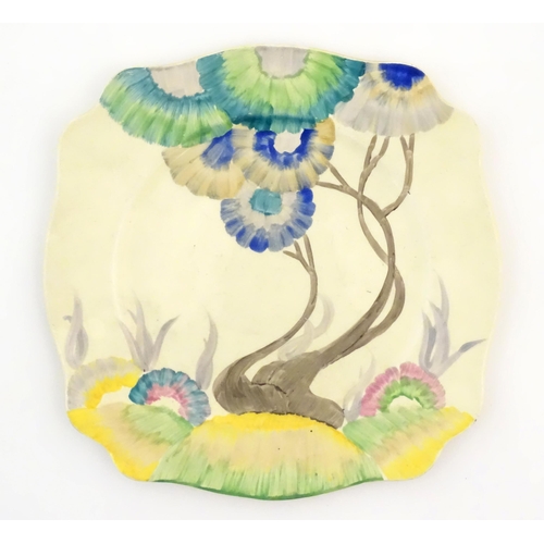 68 - A Clarice Cliff squared plate in the Rhodanthe Viscaria pattern with trees and flowers. Marked under... 