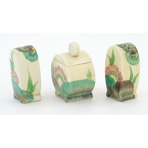 69 - A Clarice Cliff three piece cruet set comprising salt, pepper and mustard pot, with floral decoratio... 