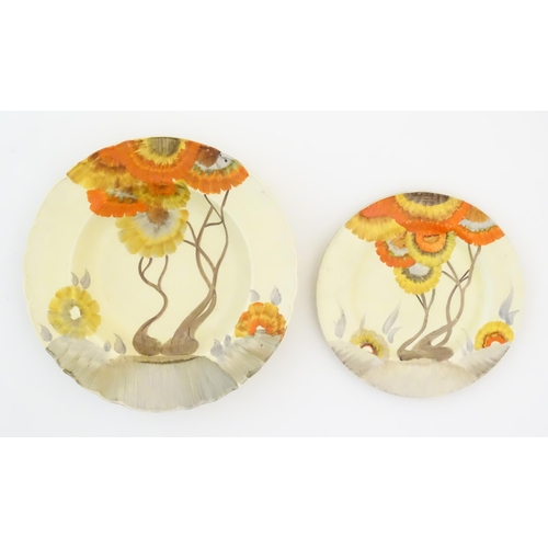 71 - A Clarice Cliff soup bowl and plate in the Rhodanthe pattern, decorated with trees and flowers. Soup... 