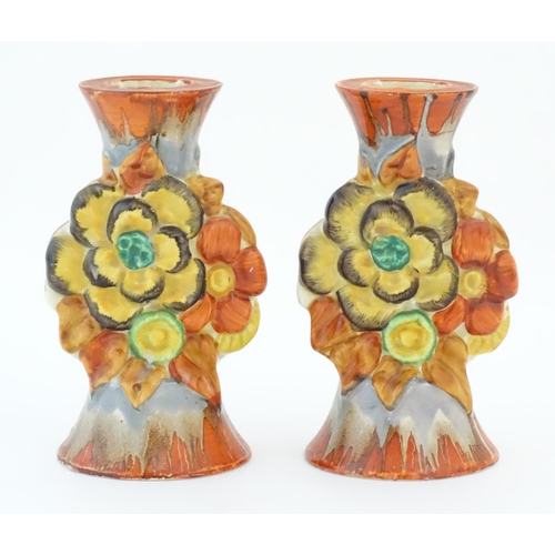 74 - A pair of Clarice Cliff candlesticks in the My Garden pattern, decorated with flowers and foliage. M... 