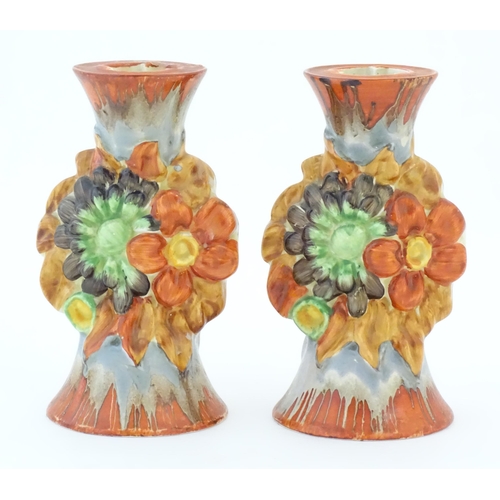 74 - A pair of Clarice Cliff candlesticks in the My Garden pattern, decorated with flowers and foliage. M... 