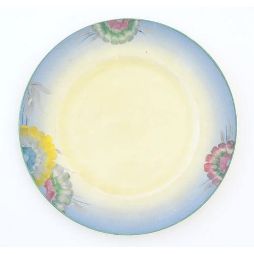 75 - A Clarice Cliff plate decorated with a floral border. Marked under. Approx. 10