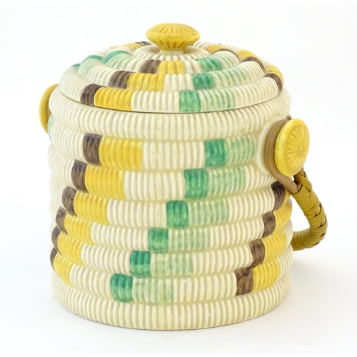 77 - A Clarice Cliff biscuit jar / barrel with swing handle in the Raffia pattern. Marked Bizarre by Clar... 